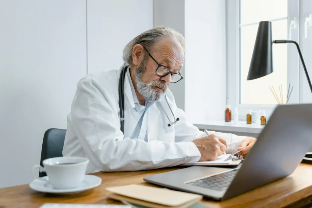 Doctor reviewing patient notes in a medical office for a guide on finding the best TRT online services.