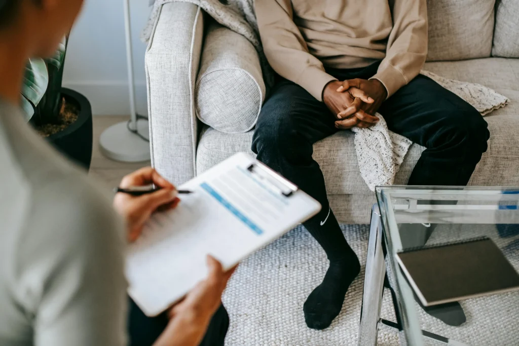 Man speaking with a medical specialist in a counselling session for a TRT guide covering hormone health and treatment options.