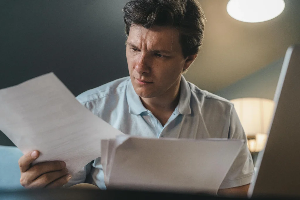 A man reviewing his health records and TRT options like GameDay Men's Health to determine if a franchise clinic is worth it.