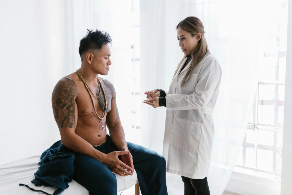 Doctor consulting with a male patient during a medical appointment about testosterone dosage for TRT and treatment planning.