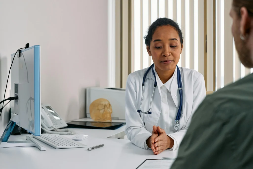 Doctor consulting with a patient during a hormone treatment discussion about clomiphene vs enclomiphene in a modern medical clinic.