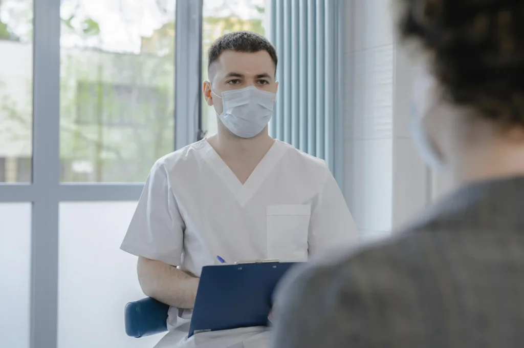 Healthcare professional consulting with a patient in a clinic during a discussion about Maximus TRT reviews and testosterone replacement therapy options.