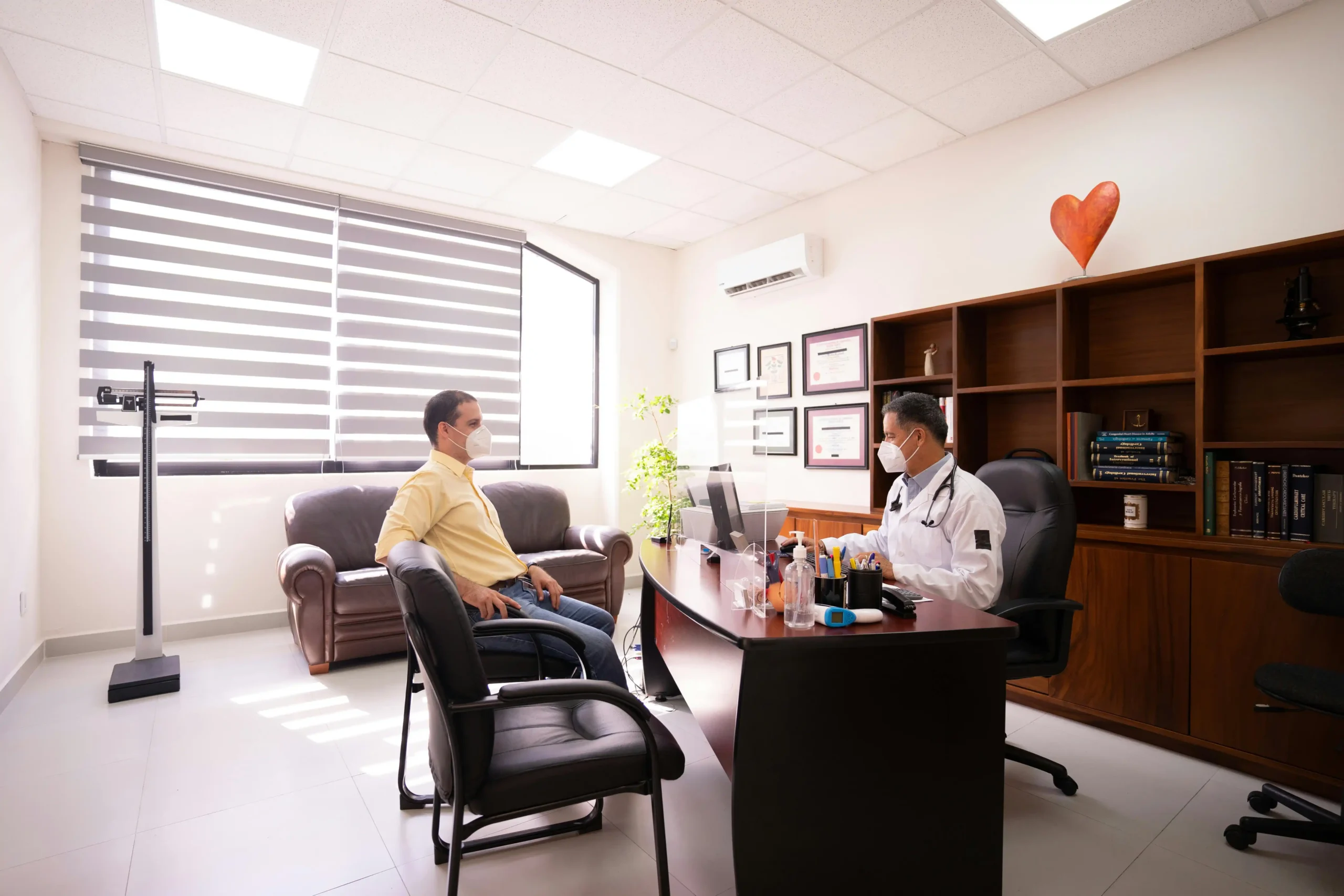 Licensed healthcare provider reviewing lab results with a male patient during a TRT consultation, illustrating how TRT dosage is personalized based on individual factors.