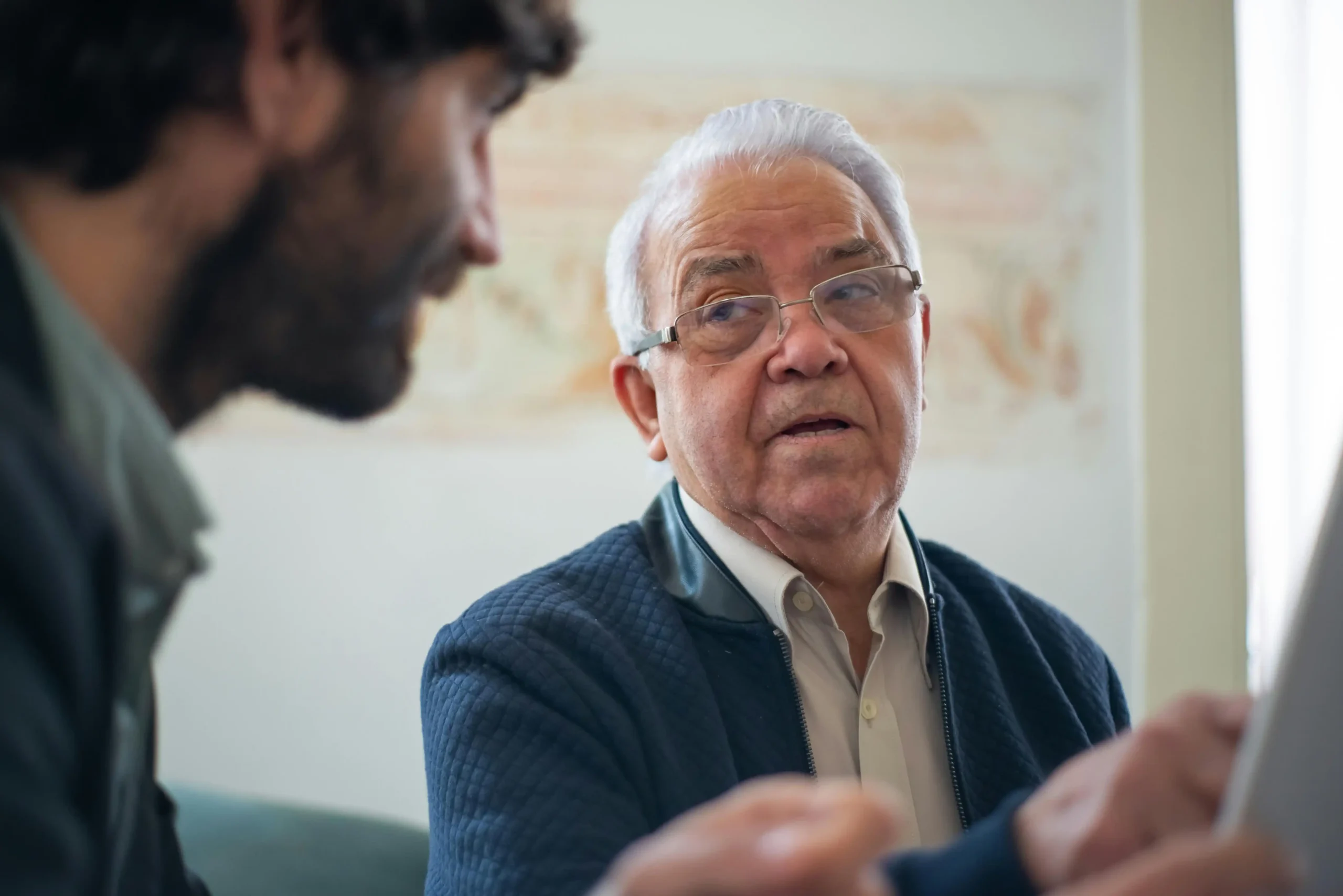 Man in a clinic reviewing lab results with a licensed provider, illustrating the safety considerations of testosterone replacement therapy.