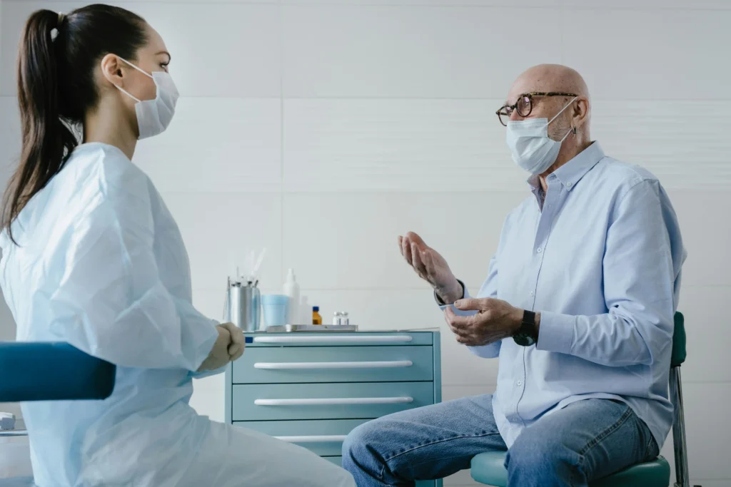Doctor consulting with an older patient in a clinic while discussing hormone treatment options and comparing fountain trt vs trt nation.
