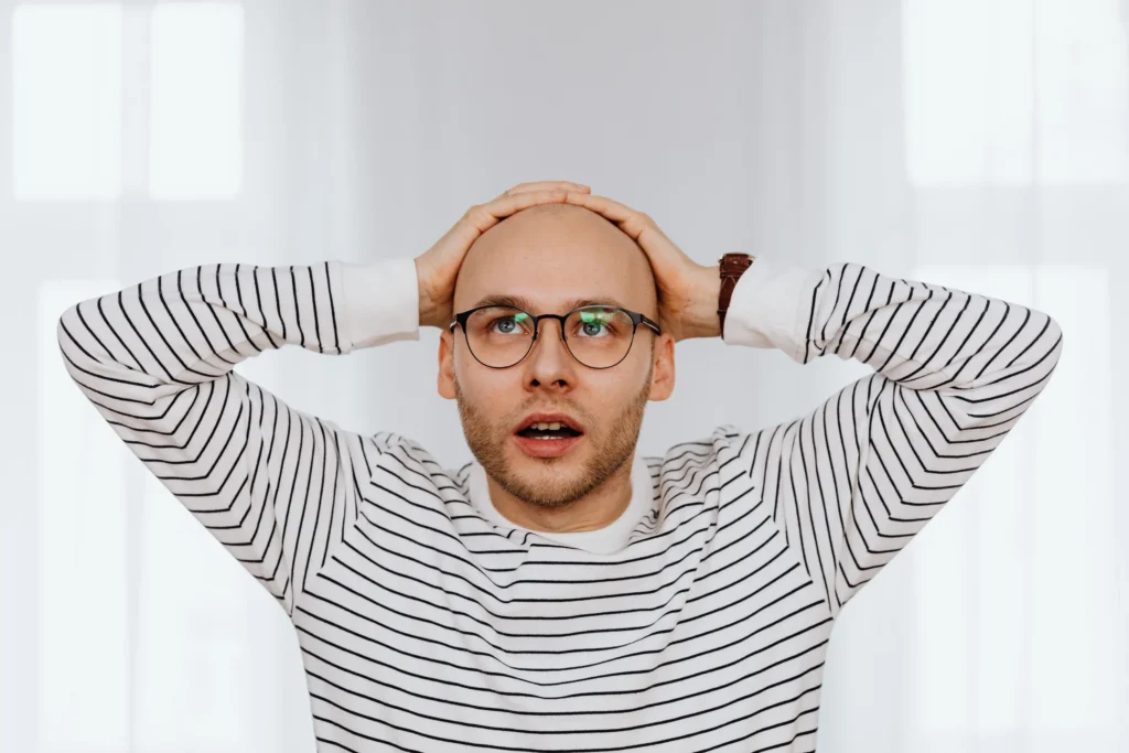 Close-up of a man experiencing hair loss, representing finasteride vs minoxidil results and expectations for hair restoration.