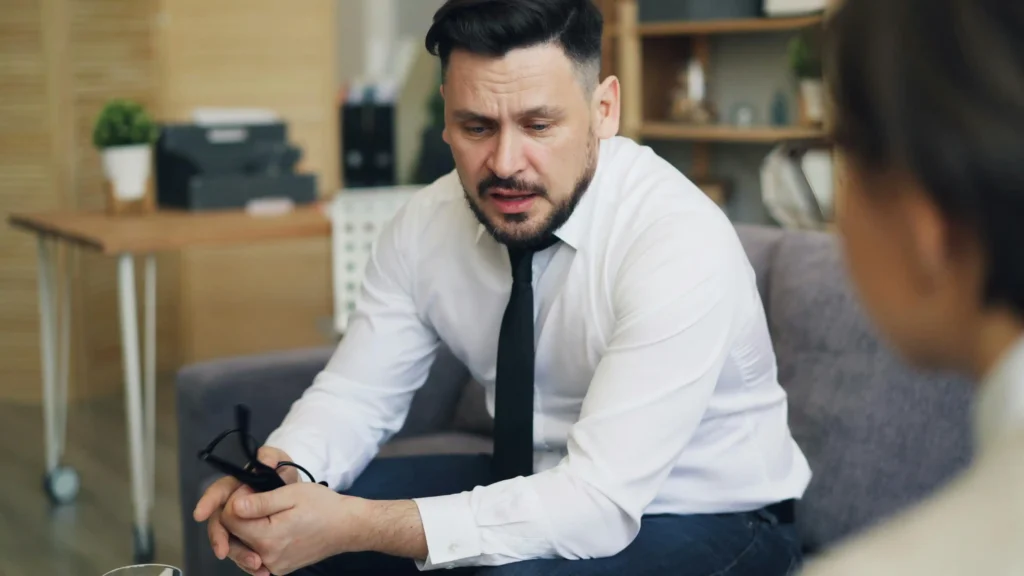 Man speaking with a medical provider during a Hims vs Keeps review of online hair restoration services.