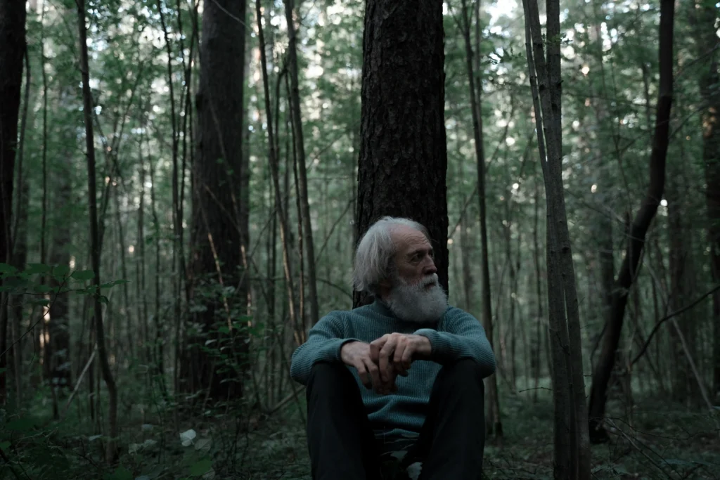 Older man in a forest reflecting on age-related changes associated with low testosterone over 40.