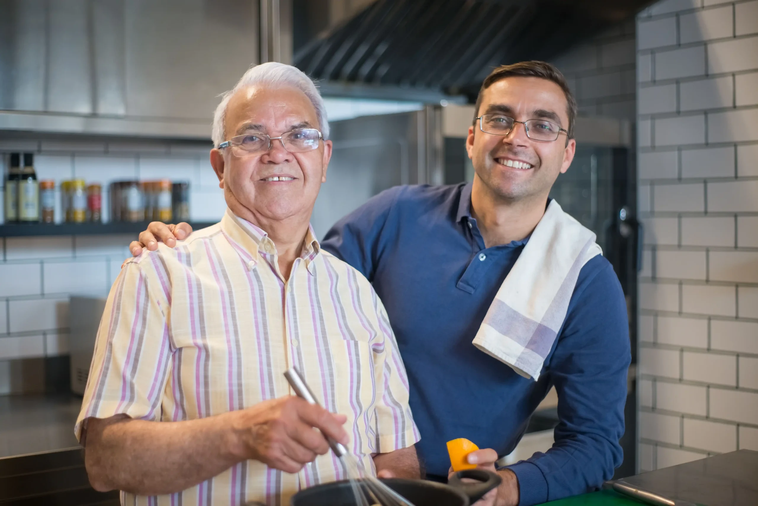 Older and younger men discussing normal testosterone levels while preparing food together.