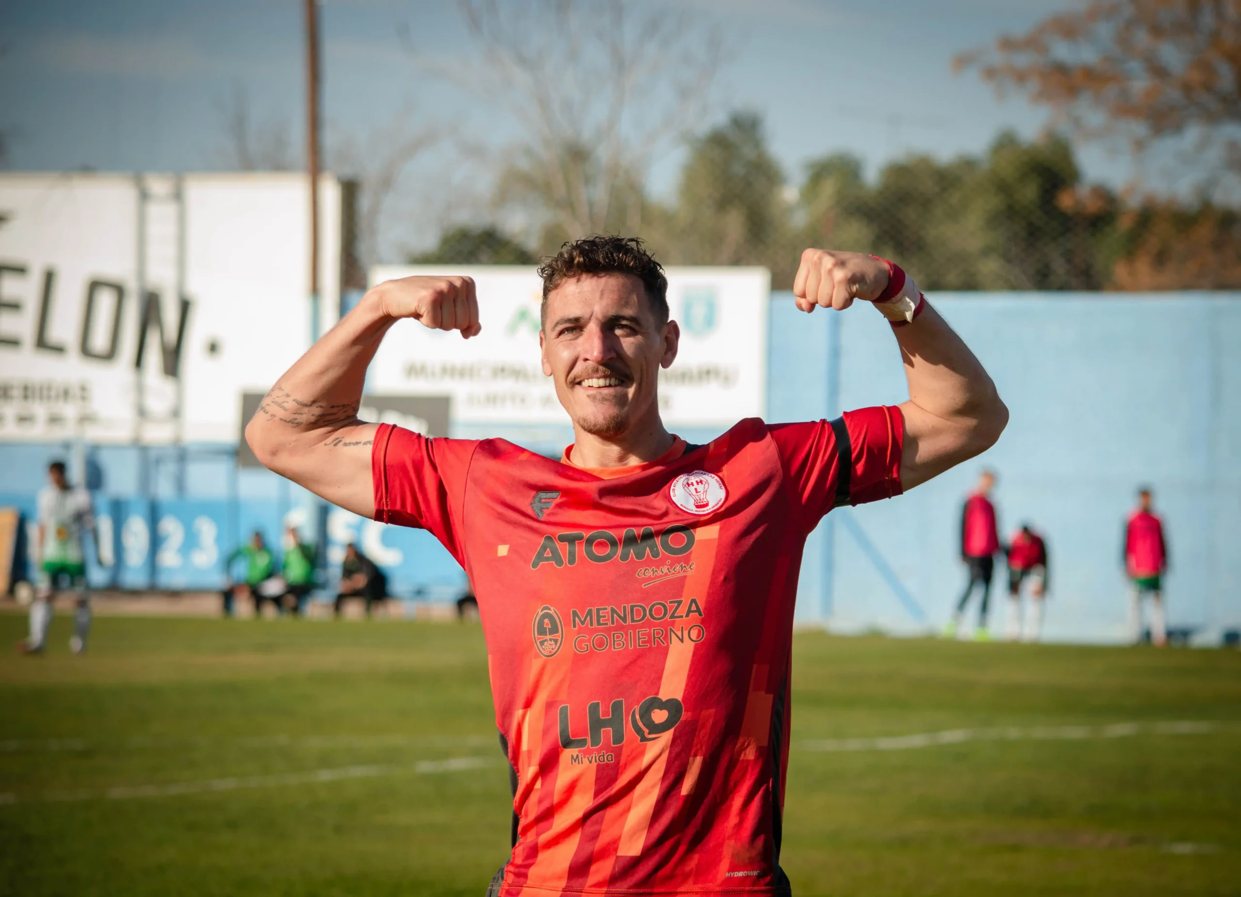 Athlete flexing on a soccer field while representing the benefits of sermorelin therapy.