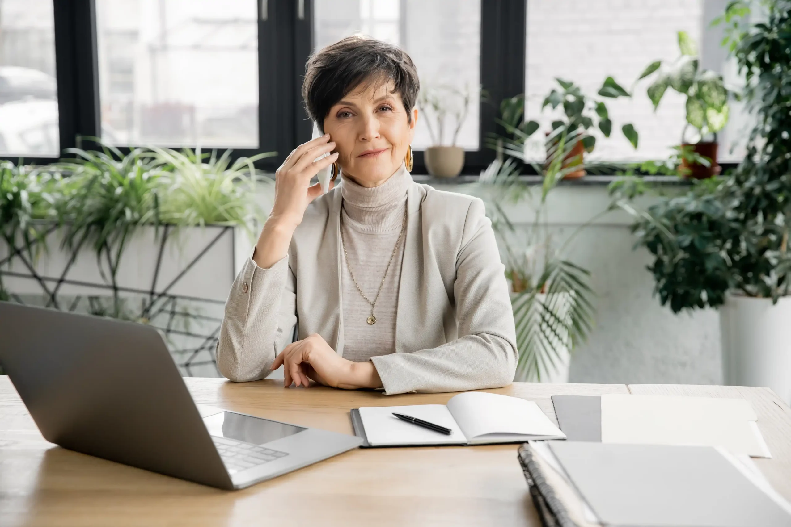 A smiling mature businesswoman looking at the camera in an office
