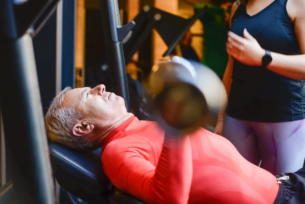 Man using a chest press machine as part of a workout to increase testosterone.