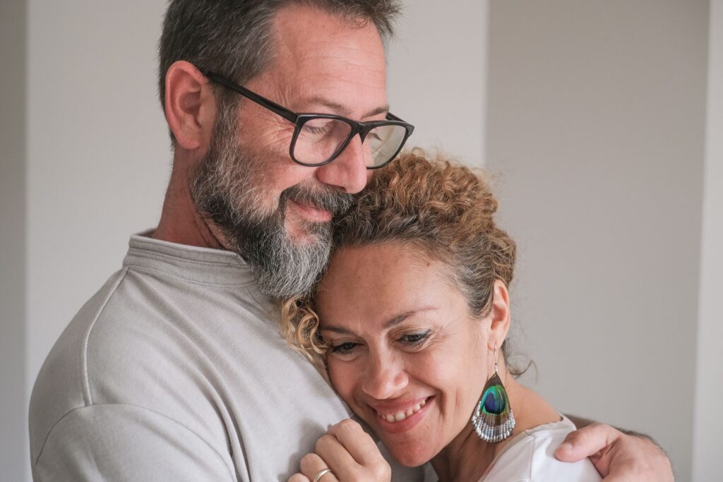 A couple in their forties embracing at home